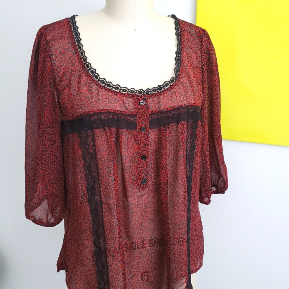 Red top with lace details. Sheer 3/4 sleeves. Size: L